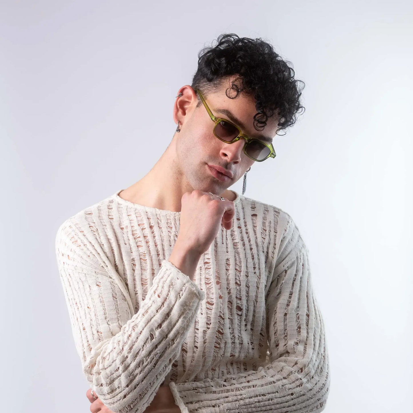 A male model wearing Exposure Sunglasses polarized sunglasses with green frames and green lenses, posing against a white background.