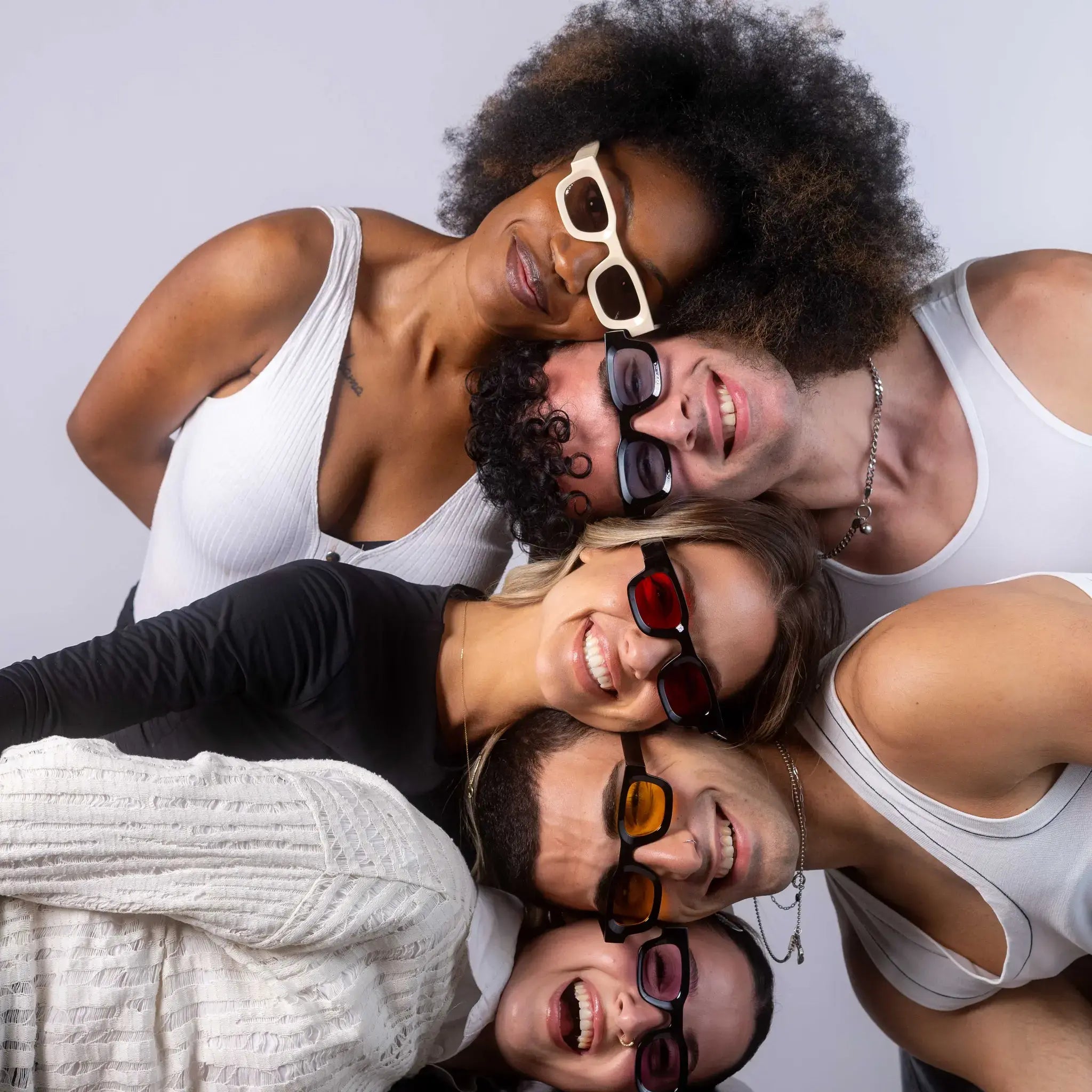 Five models wearing Exposure Sunglasses polarized sunglasses with black frames and tinted lenses, posing against a white background.